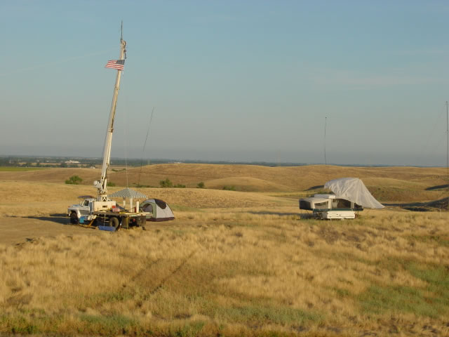 another view, the crane truck with boom raised, antennas at the top
