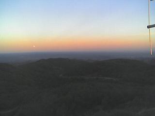 Sunset lights up the haze as the moon rises.